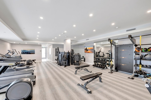 gym with a raised ceiling