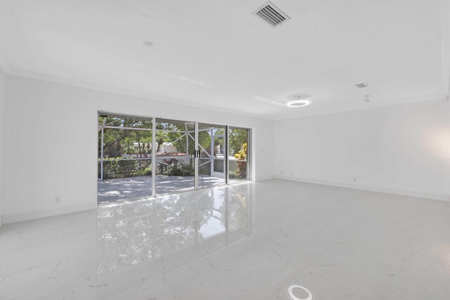 unfurnished room with crown molding