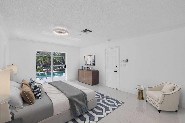 bedroom featuring ornamental molding, a textured ceiling, and access to outside