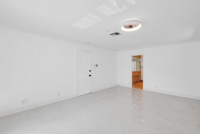 spare room featuring ornamental molding