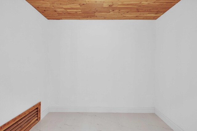 unfurnished room with wooden ceiling