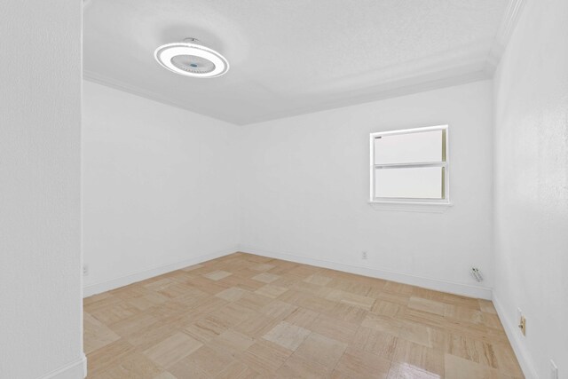 unfurnished room with crown molding