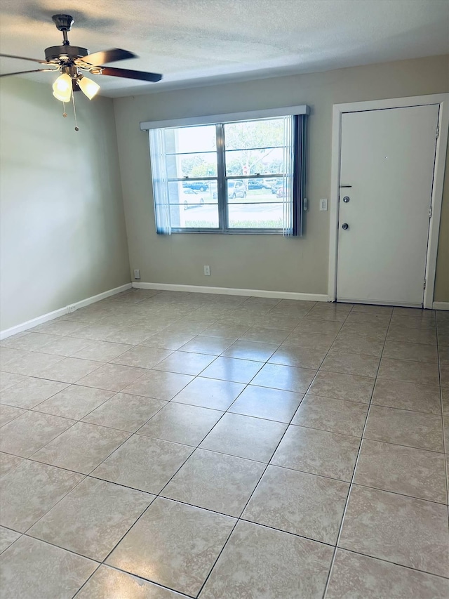 interior space featuring ceiling fan and a textured ceiling