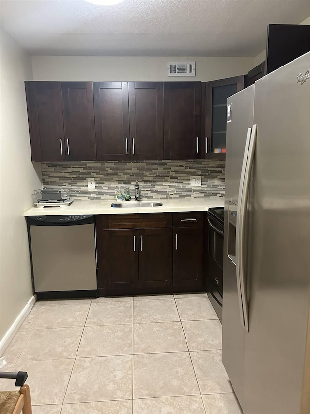 kitchen featuring stainless steel appliances, dark brown cabinets, and sink