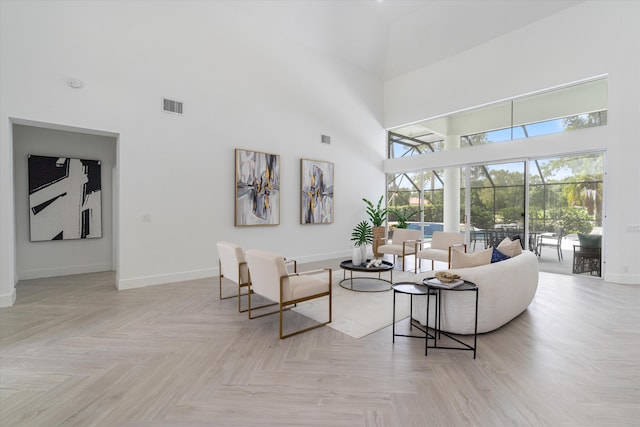 living room featuring light parquet floors and a high ceiling