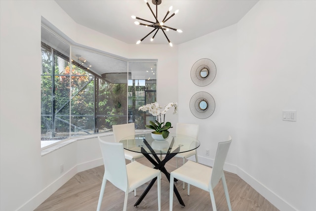 dining area featuring a healthy amount of sunlight and a chandelier