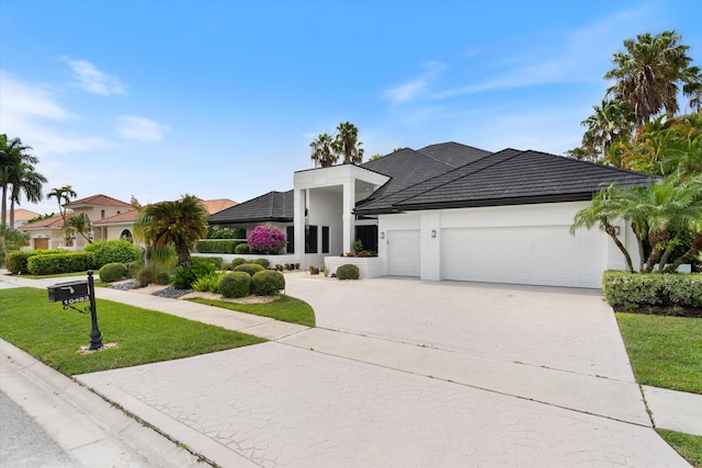 view of front of home featuring a garage and a front yard