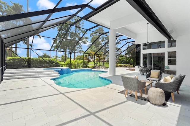 view of swimming pool with glass enclosure and a patio area