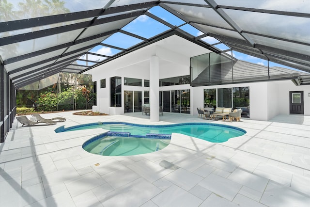 view of swimming pool with a lanai, a patio area, and an in ground hot tub