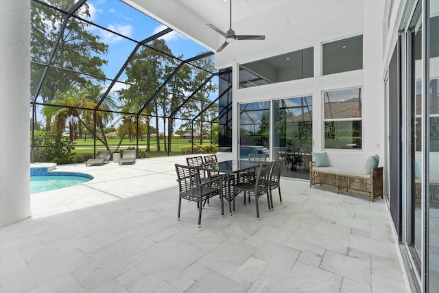 view of patio with glass enclosure and ceiling fan