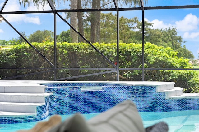 view of swimming pool with a lanai