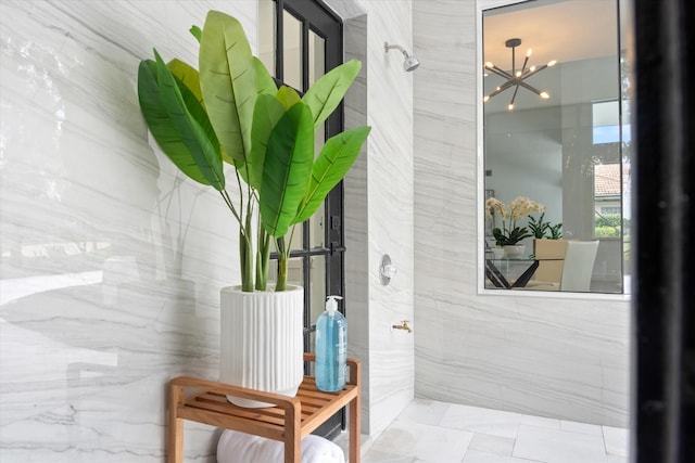 doorway to outside featuring a notable chandelier and tile patterned floors