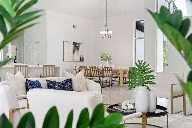 living room with hardwood / wood-style floors and a notable chandelier