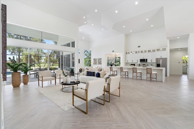 living room with a high ceiling and light parquet flooring