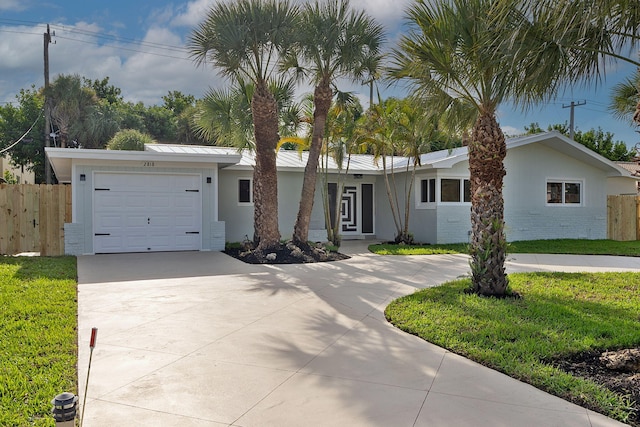 ranch-style home with a garage and a front lawn