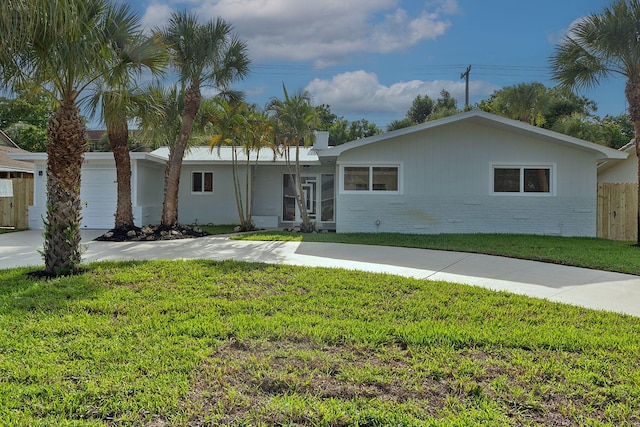 single story home with a garage and a front lawn