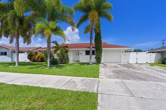 ranch-style home with a garage and a front lawn