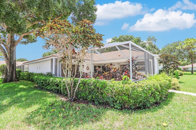 exterior space featuring a yard and a lanai