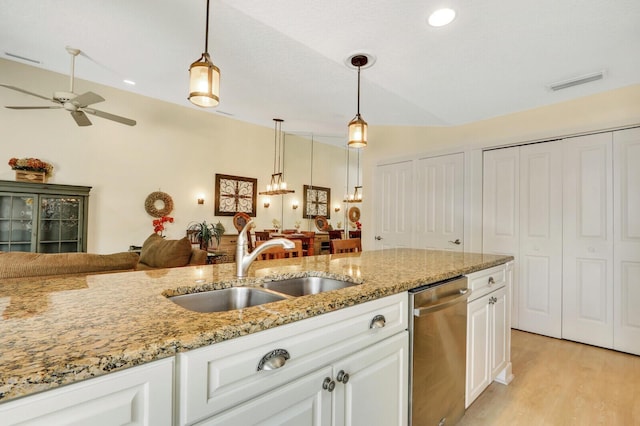 kitchen with sink, white cabinetry, decorative light fixtures, dishwasher, and light stone countertops