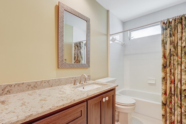 full bathroom with vanity, shower / bath combination with curtain, and toilet