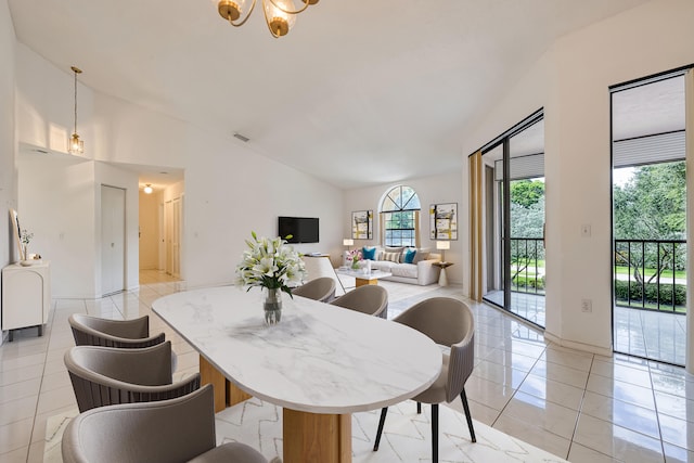 tiled dining space with a chandelier and lofted ceiling