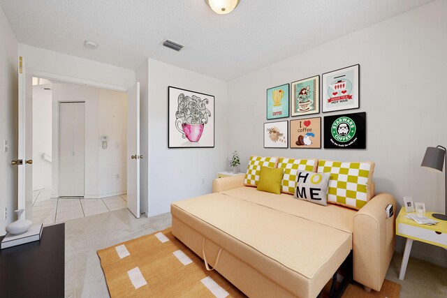 tiled bedroom featuring a textured ceiling