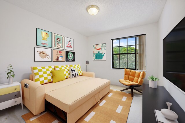 bedroom with a textured ceiling and light colored carpet