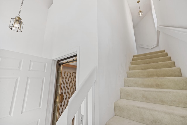 staircase featuring a towering ceiling