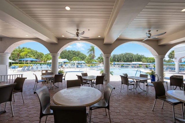 view of patio featuring ceiling fan and a community pool