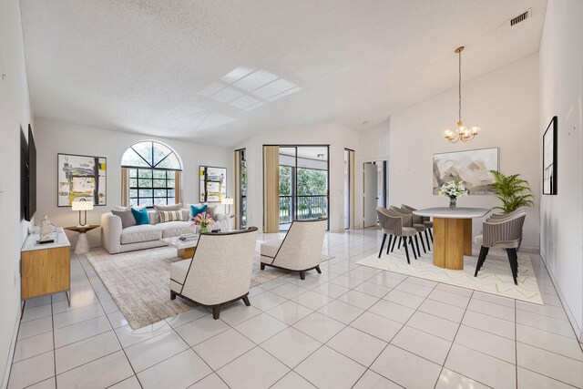 tiled living room with high vaulted ceiling, a chandelier, and a textured ceiling