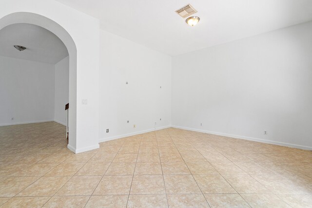 unfurnished room with hardwood / wood-style floors, ceiling fan, and a raised ceiling