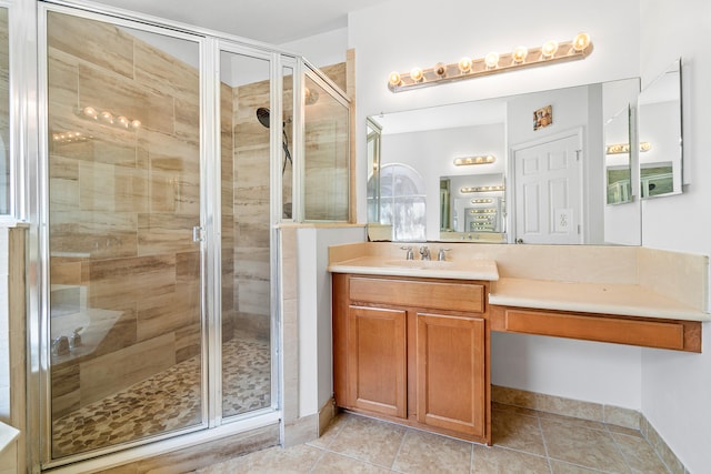 bathroom with vanity, an enclosed shower, and tile patterned flooring