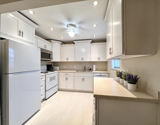 kitchen featuring ceiling fan, light hardwood / wood-style floors, sink, white appliances, and white cabinets