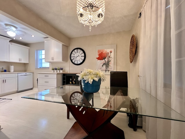 dining space with a textured ceiling and an inviting chandelier