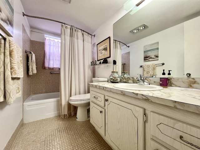 full bathroom with toilet, shower / tub combo, vanity, and tile patterned floors