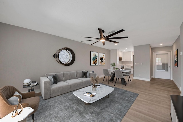 living room with hardwood / wood-style flooring and ceiling fan