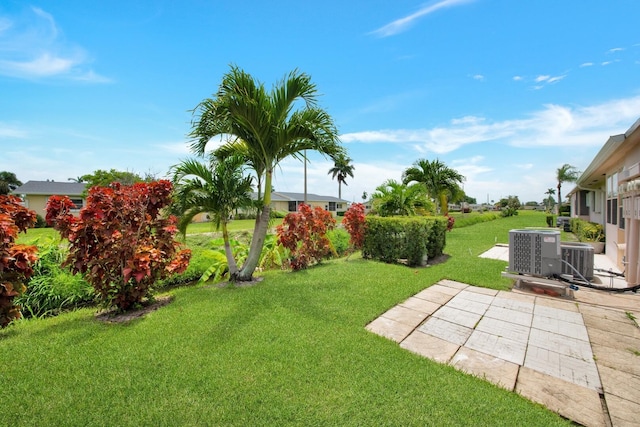 view of yard with cooling unit and a patio