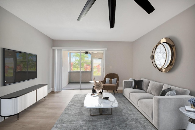 living room featuring ceiling fan and light hardwood / wood-style floors