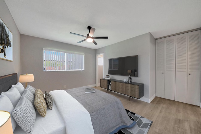 bedroom featuring ceiling fan, a closet, and light hardwood / wood-style flooring