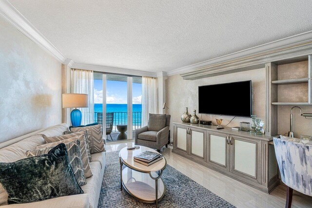 living room featuring a textured ceiling, light tile patterned floors, and ornamental molding