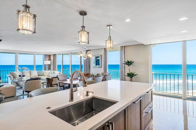 kitchen featuring a water view and floor to ceiling windows