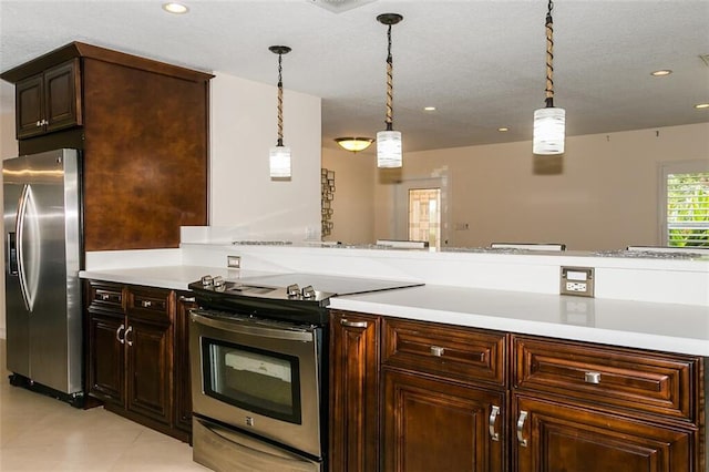 kitchen featuring dark brown cabinets, a textured ceiling, appliances with stainless steel finishes, and decorative light fixtures