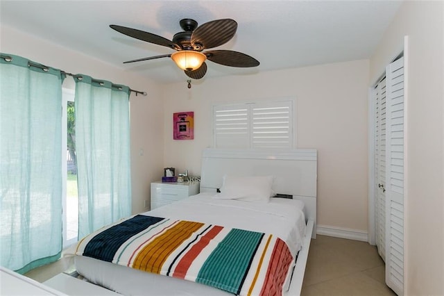 tiled bedroom with ceiling fan