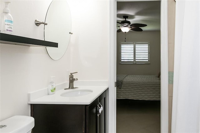 bathroom featuring vanity, toilet, and ceiling fan