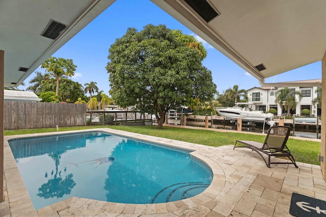 view of pool featuring a patio area and a lawn