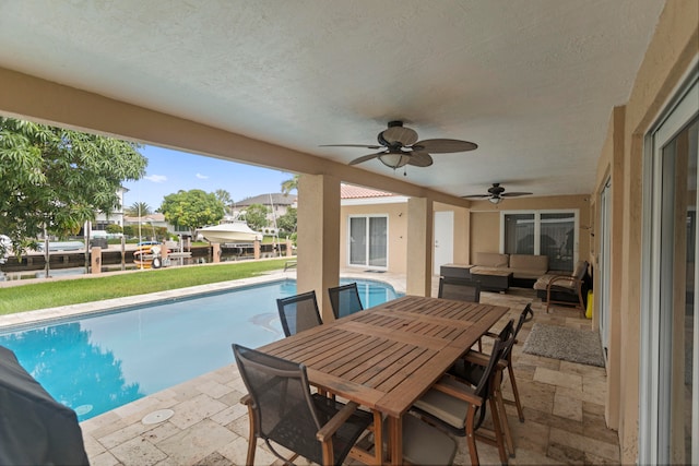 view of pool featuring a patio, ceiling fan, and an outdoor hangout area