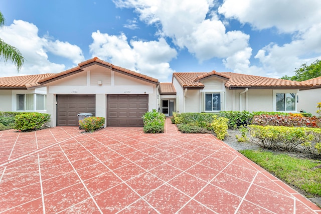 mediterranean / spanish house with a garage