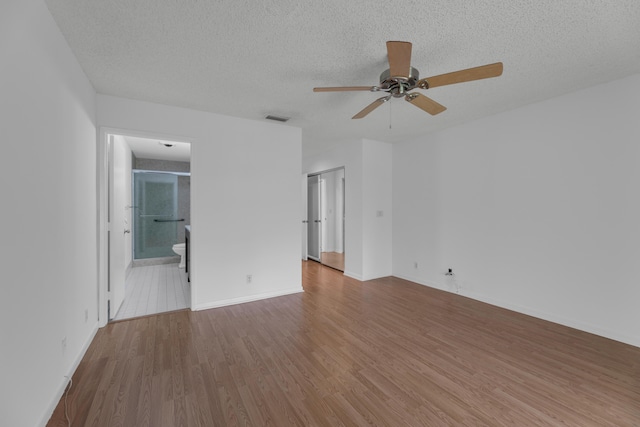 unfurnished room featuring a textured ceiling, tile patterned floors, and ceiling fan