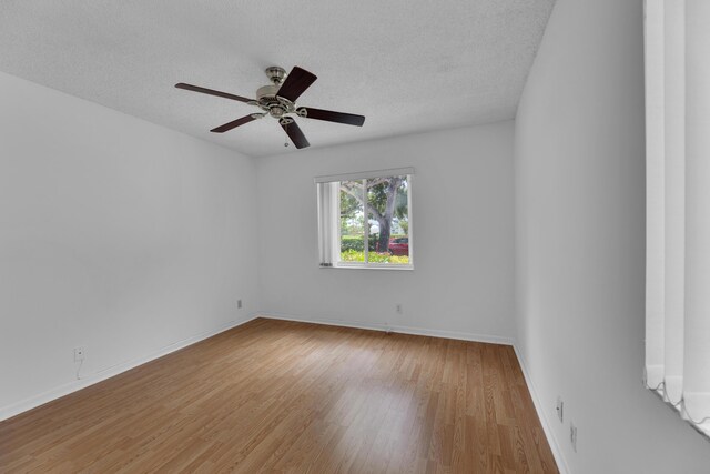 unfurnished room featuring a textured ceiling, ceiling fan, and light hardwood / wood-style floors