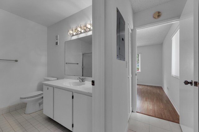 bathroom with vanity, toilet, and tile patterned floors